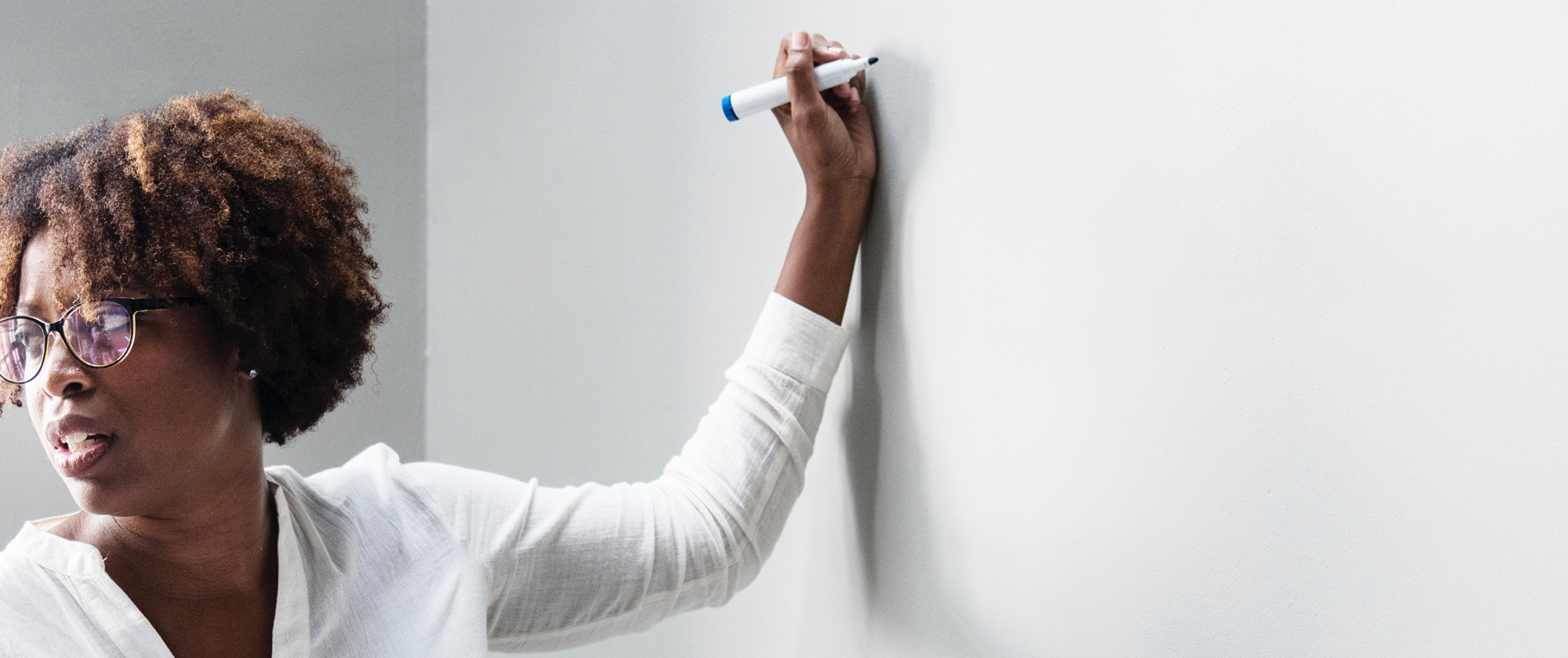 Female teacher writing on board